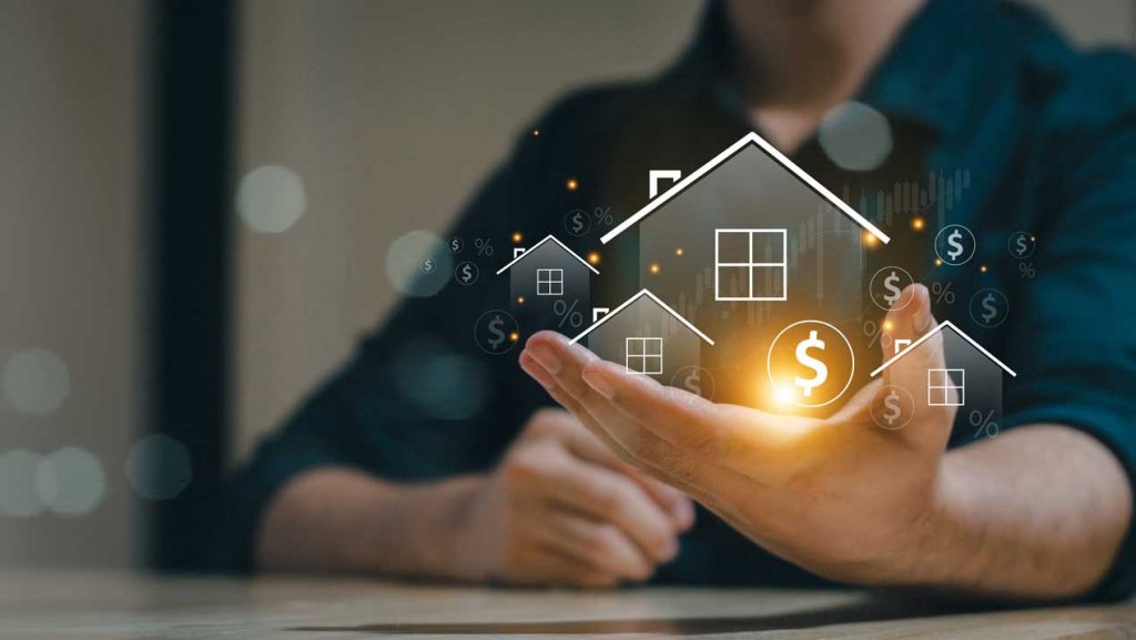 Hand mit leuchtender Häusergrafik und Dollarzeichen als Symbol für Immobilienfinanzierung